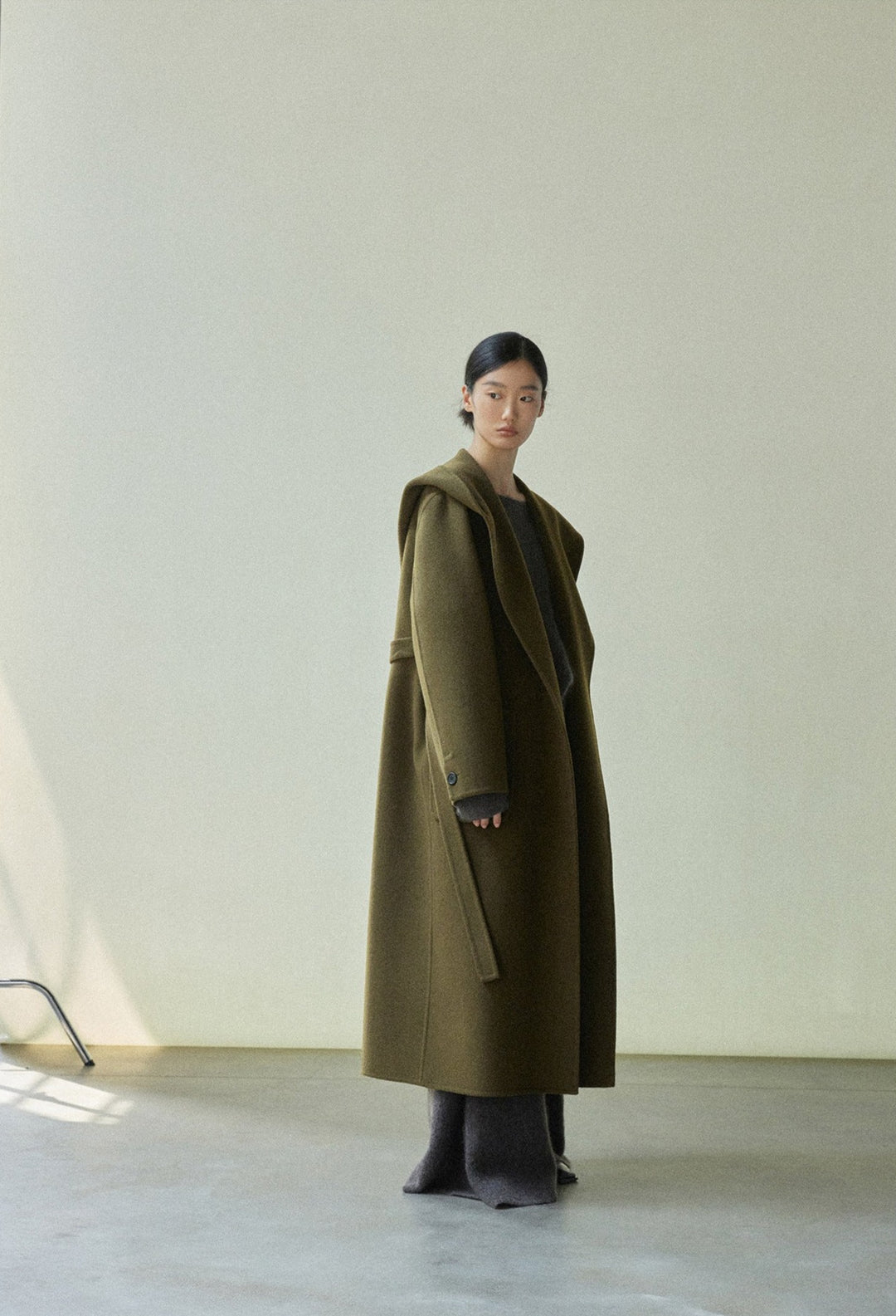 Full-length view of the olive green robe coat, displaying its clean and elegant silhouette.