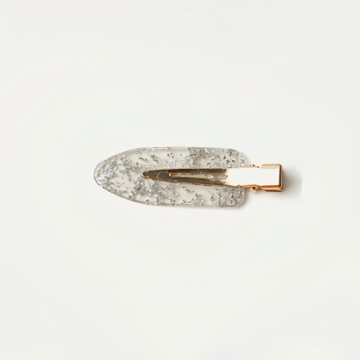 This image features the Transparent Resin with Silver Flakes no-crease hair clip, showcasing its chic and versatile sparkle. Measuring 6 cm, this clip is ideal for providing a gentle and secure hold, keeping your hair smooth and free from unwanted dents.