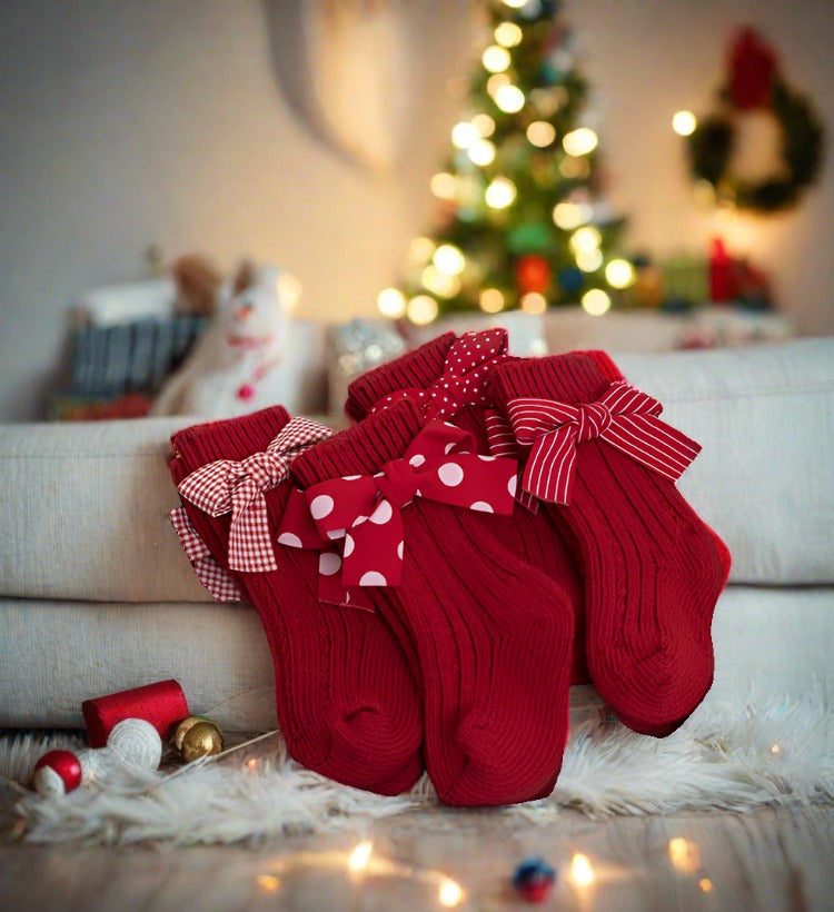 Get your children ready for the holiday season with these charming red socks featuring bows, ideal for festive celebrations and creating cheerful memories.