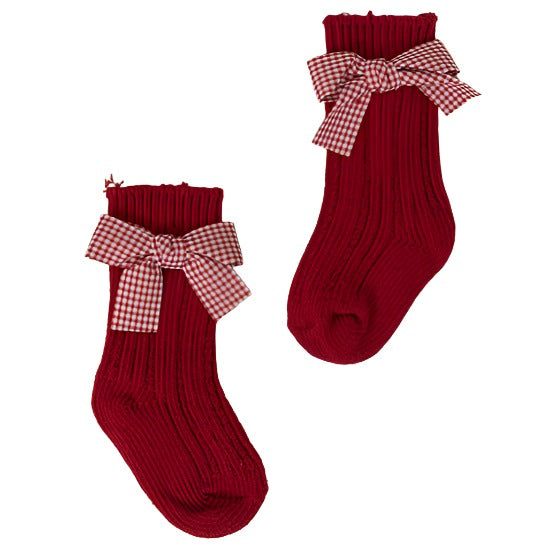 Festive baby girls' socks in red with a cute checkered bow.