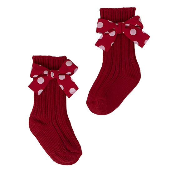 A pair of red socks with large bows is a holiday classic for girls.