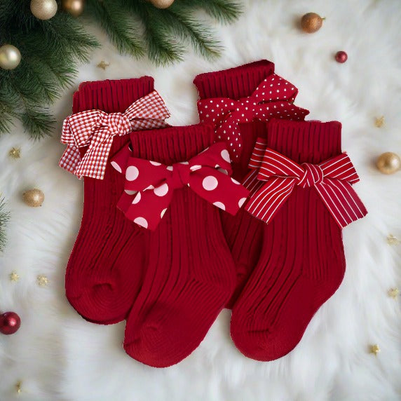 Brighten up your child's Christmas with these adorable red socks adorned with bows, perfect for adding a festive touch to their holiday ensemble.