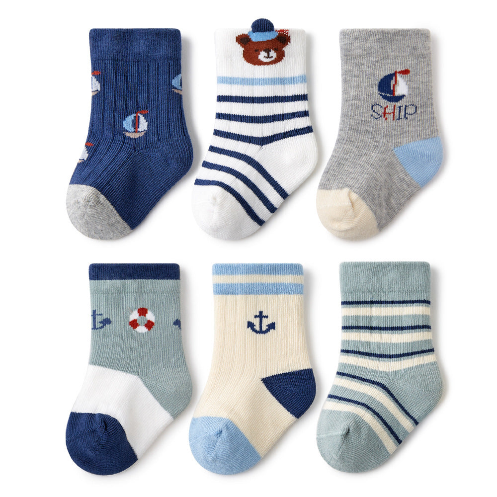 An adorable assortment of six pairs of baby socks with nautical themes, including anchors, ships, and stripes, in soothing blue and white tones.