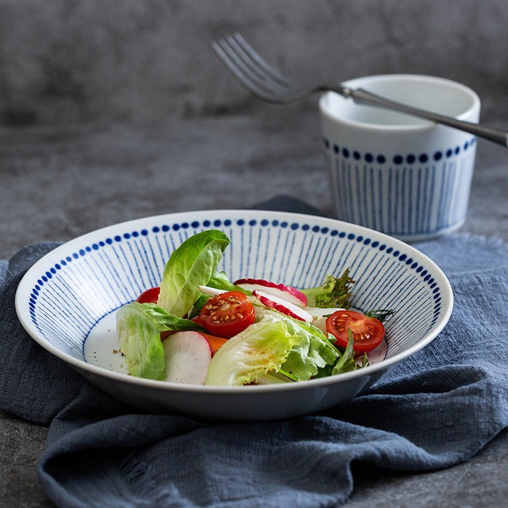 The deep plate and drinking cup as part of a beautifully arranged table, showcasing their elegance.