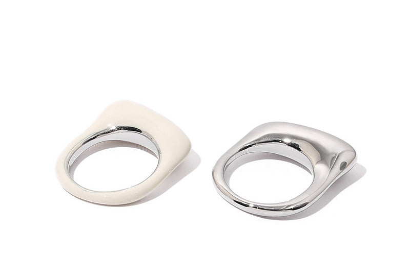 The Echo Duo set is showcased together, highlighting the contrasting yet complementary colors and finishes of the white enamel and silver metal rings. The smooth surfaces and geometric shapes create a modern, sleek aesthetic.