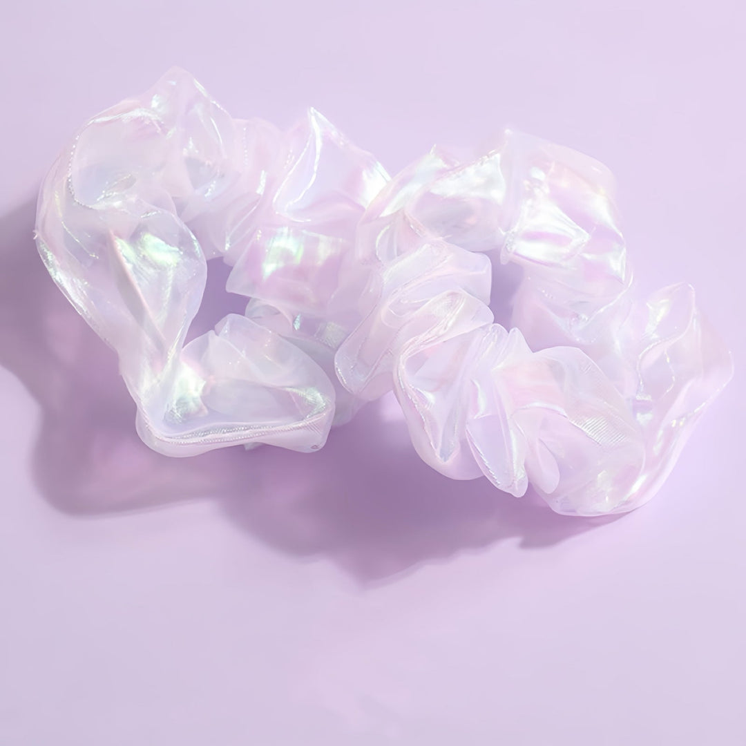 A detailed view of the scrunchie, emphasizing its textured, ruffled design and light-catching qualities. With its approximately 9 cm diameter, this scrunchie’s luxurious, opalescent shine makes it a standout addition to your hair accessories collection.