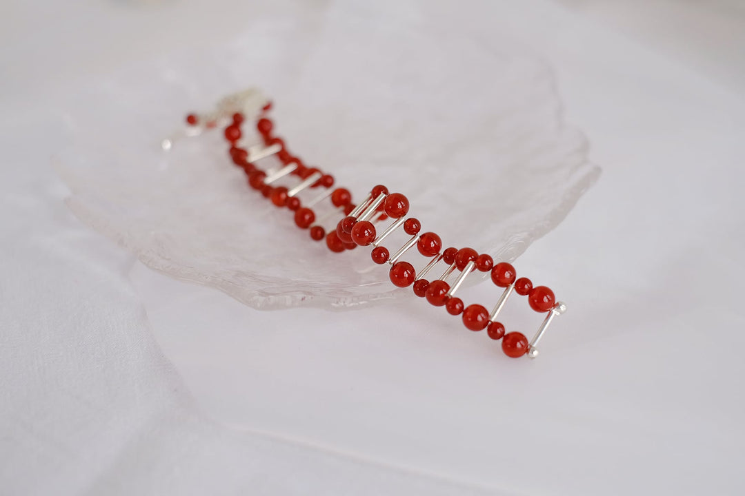 The vibrant red onyx beads and unique silver clasp add a touch of sophistication to any ensemble.