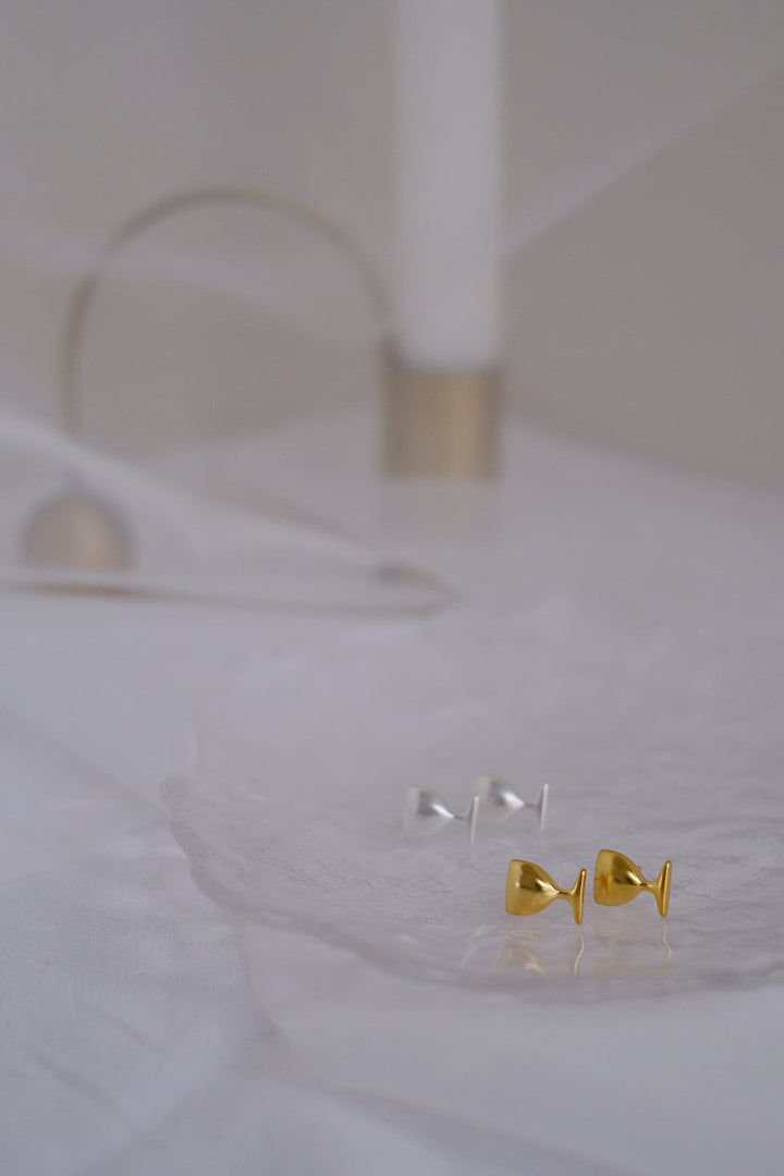 This comparison picture of the gold-plated and silver Chic Cheers stud earrings showcases the versatility and appeal of both finishes, catering to different style preferences.