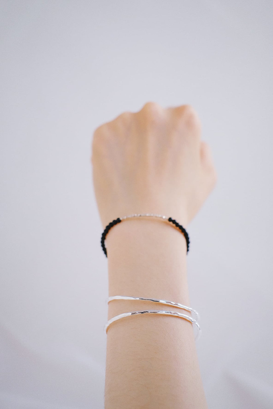 The bracelet layered with the Armor bangle.