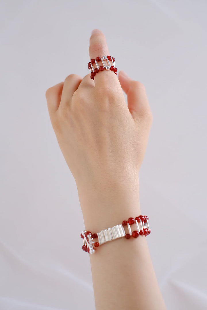 The vibrant red onyx beads complement the sterling silver accents, creating a striking ensemble.