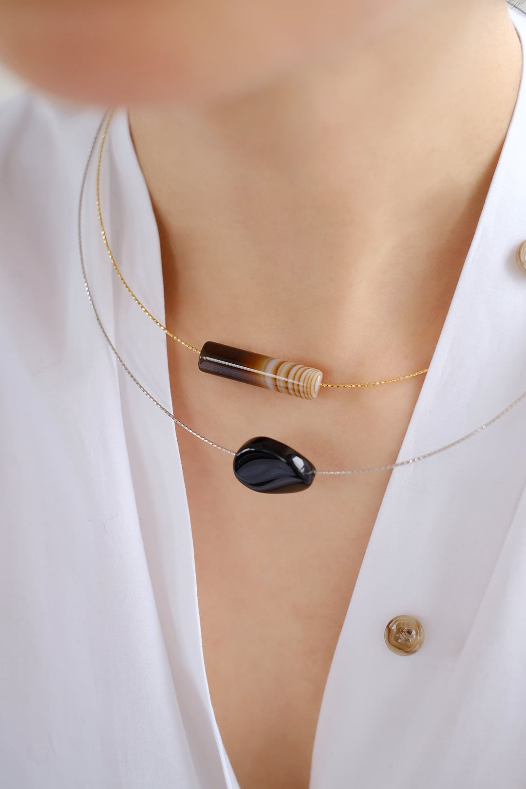 Liquorice &amp; Latte chokers worn together for a stylish layered look.