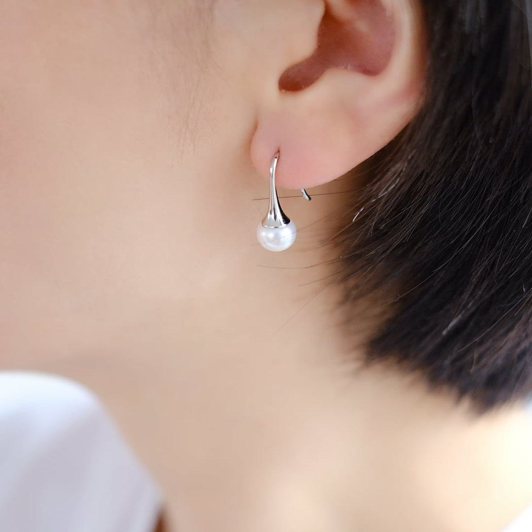 A model wearing the Elegance Dew Drop earrings, showing how they beautifully complement the earlobe.