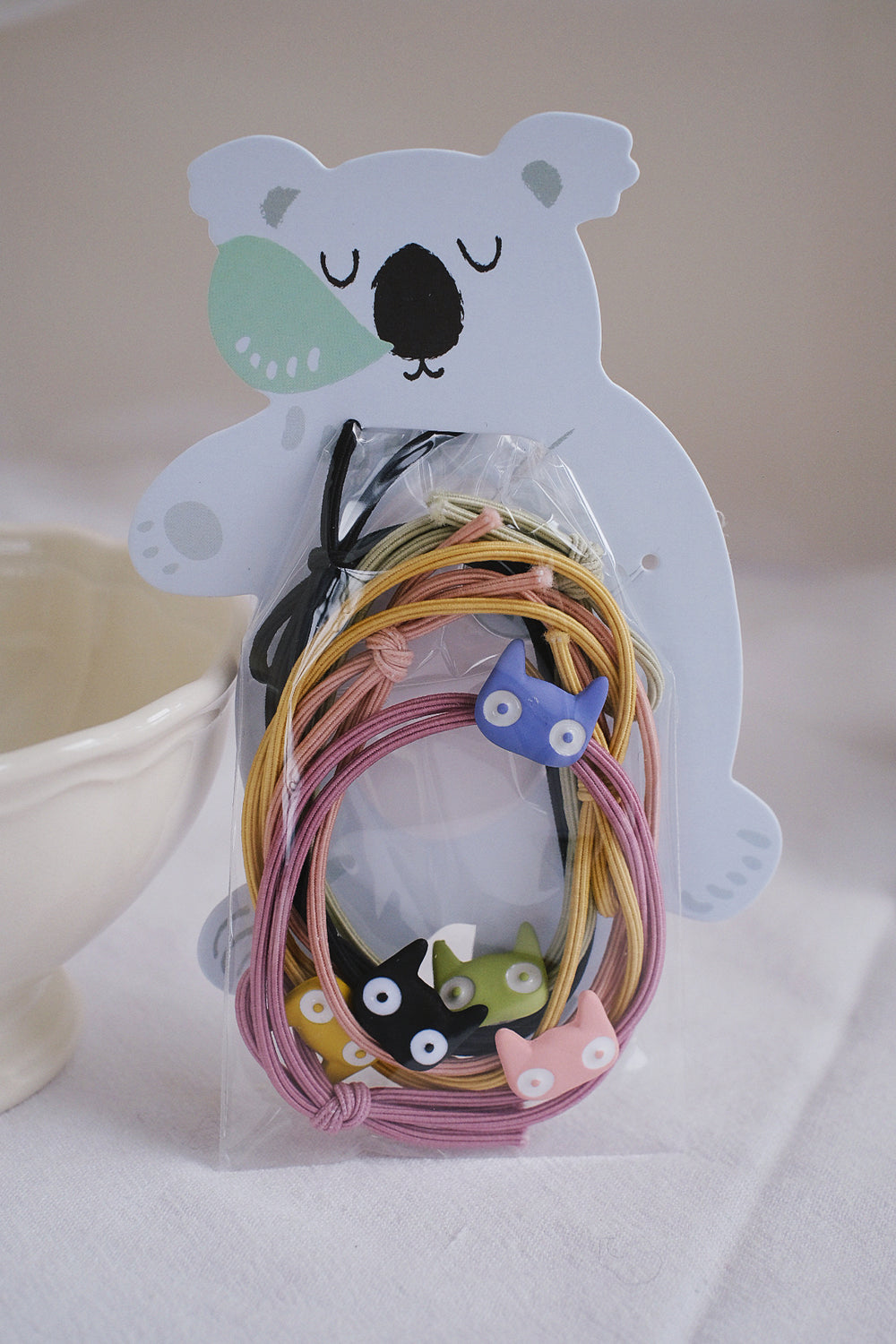 This 5-piece hair tie set features a charming bonus - a whimsical Koala bear design package.