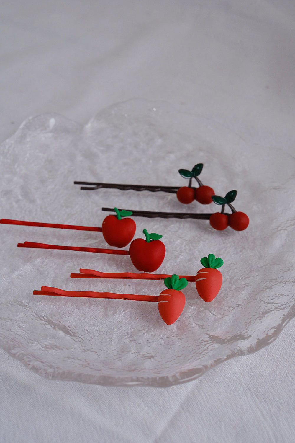 The pins come in 3 designs of cute fruit and veggie, ranging from bright orange red to dark cherry red.