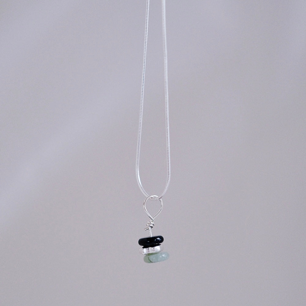 Close-up of the three-layer pendant in the black, silver, and jade option.