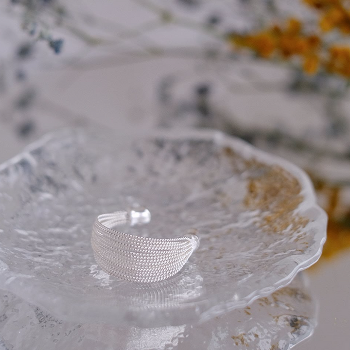 Close-up of the Silver Ripples Open Size Ring, highlighting its textured silver strands.