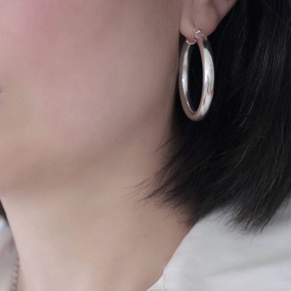 The Lunar Eclipse hoop earrings are substantial without being aggressive.