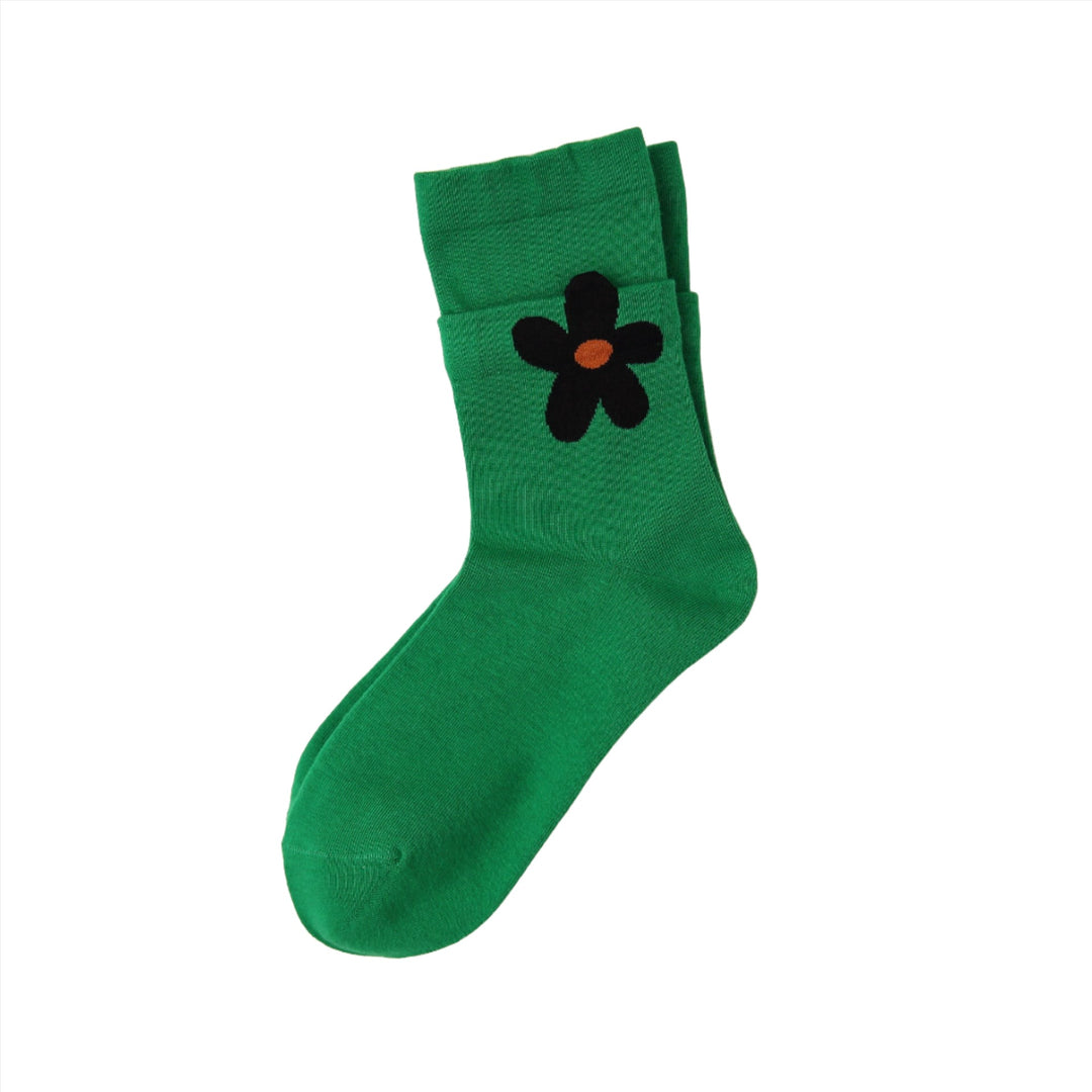 The green sock, adorned with a cute black flower, offers a charming and fun design for women and girls looking to brighten up their wardrobe.