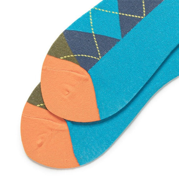 Focus on the vibrant orange toe part of the socks, contrasting beautifully with the blue and green diamond patterns, adding a pop of color to the ensemble.