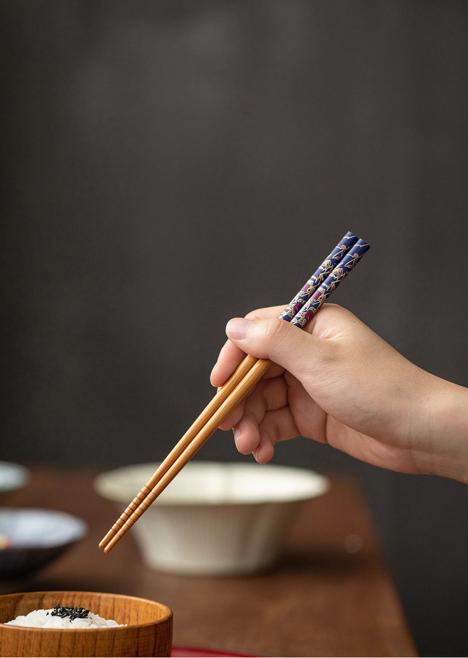 The chopsticks in use, demonstrating their beautiful design and comfortable hold.