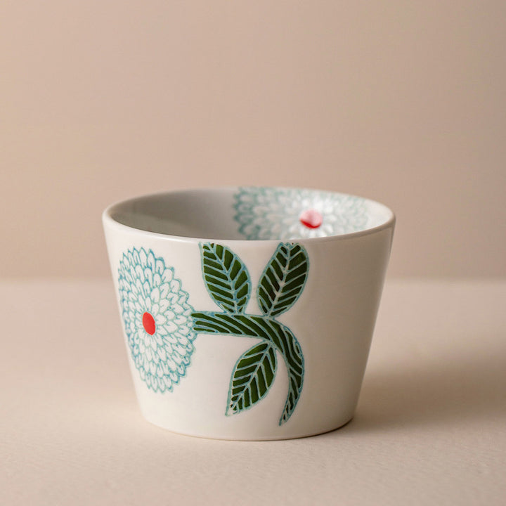 Immerse yourself in the beauty of Japanese craftsmanship with our exquisite HASAMI Yaki porcelain cups, featuring delicate Dahlia floral motifs and a refreshing color palette.