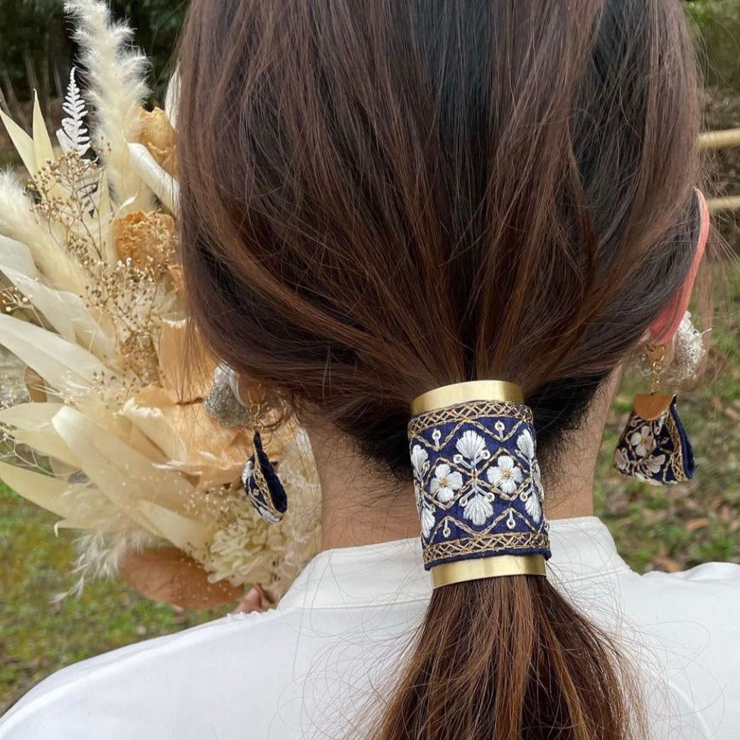 Back view of a woman wearing the embroidered hair wrap in a low ponytail, showcasing the intricate Indian embroidery.