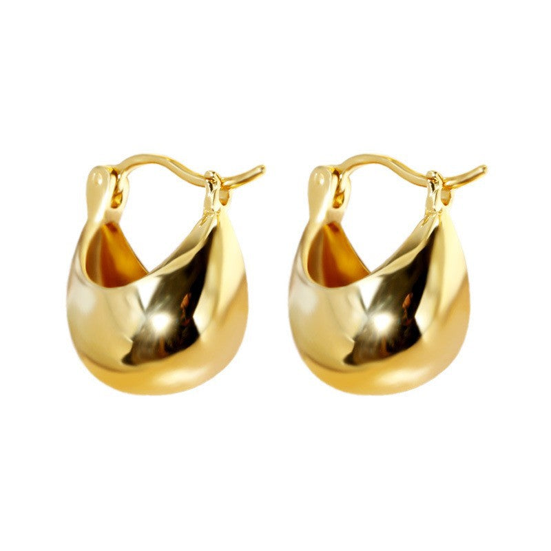 The 18k gold-plated Vessel Earrings displayed against a neutral background, showcasing their luxurious finish and elegant design.