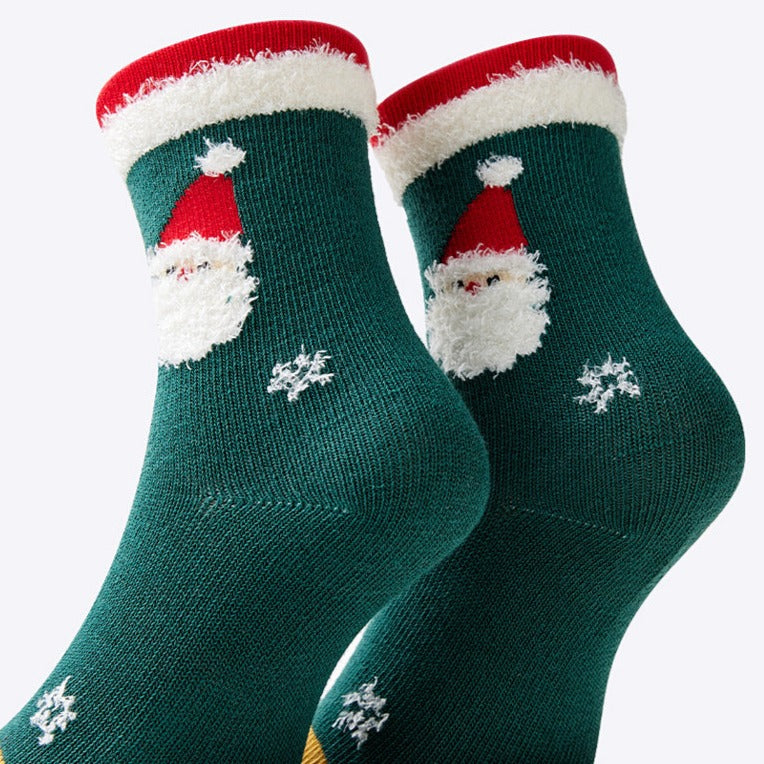 Close-up of the green socks with Santa and snowflakes, highlighting the detailed design and festive colors.