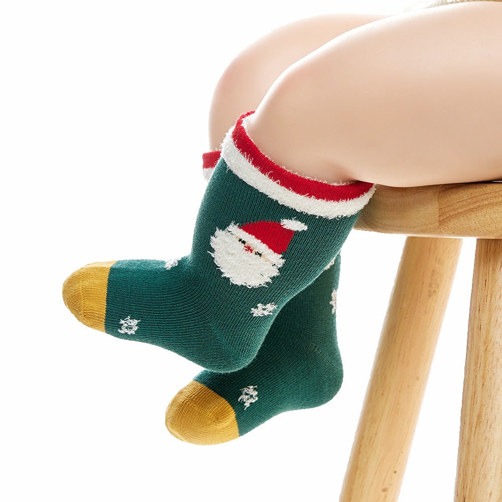 A child wearing the Santa socks, demonstrating the perfect fit and festive appearance, ideal for holiday outfits.