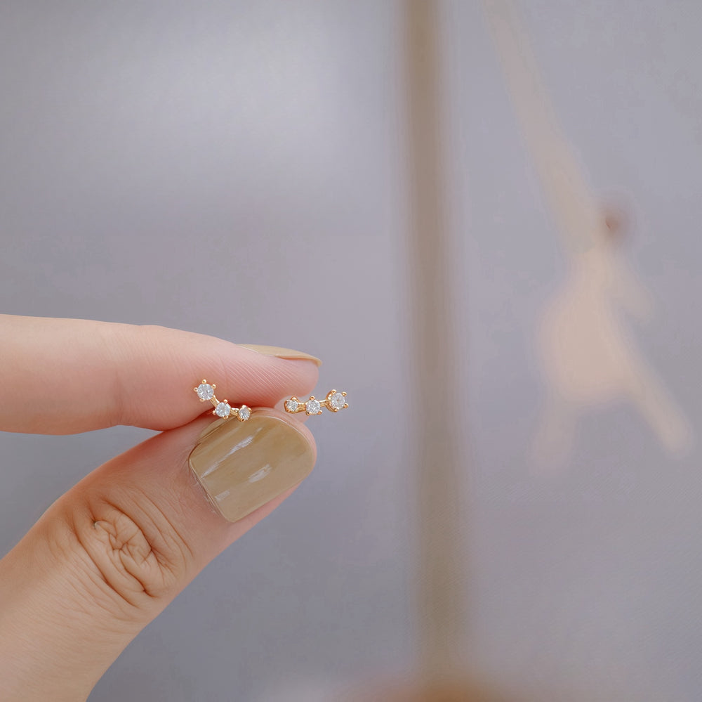 Close-up of Constellation lightweight studded earrings in gold-plated sterling silver, featuring delicate zircon stones. These petite, comfortable earrings are perfect for young children and daily wear.