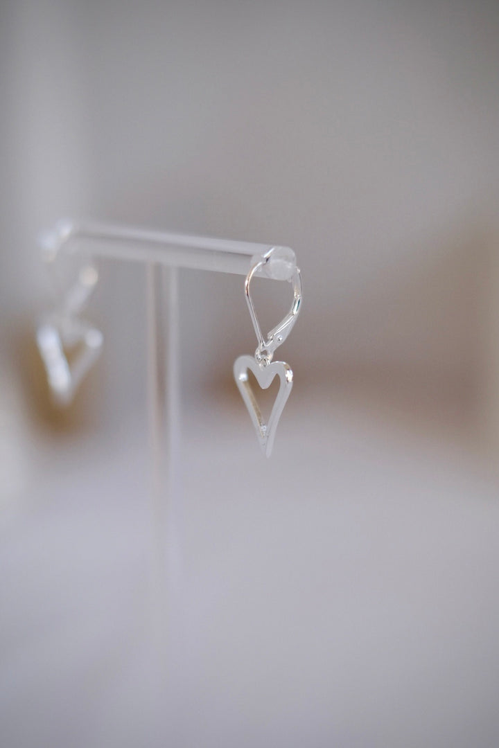 Side profile of the heart shaped earrings and their elegant hook design.