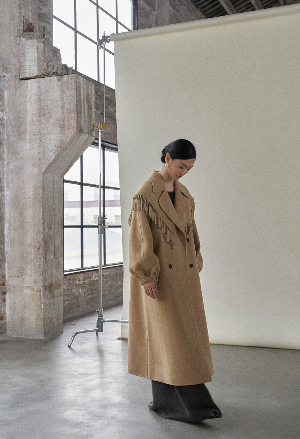 Full-length image of the camel coat, highlighting its eye-catching design and warmth.